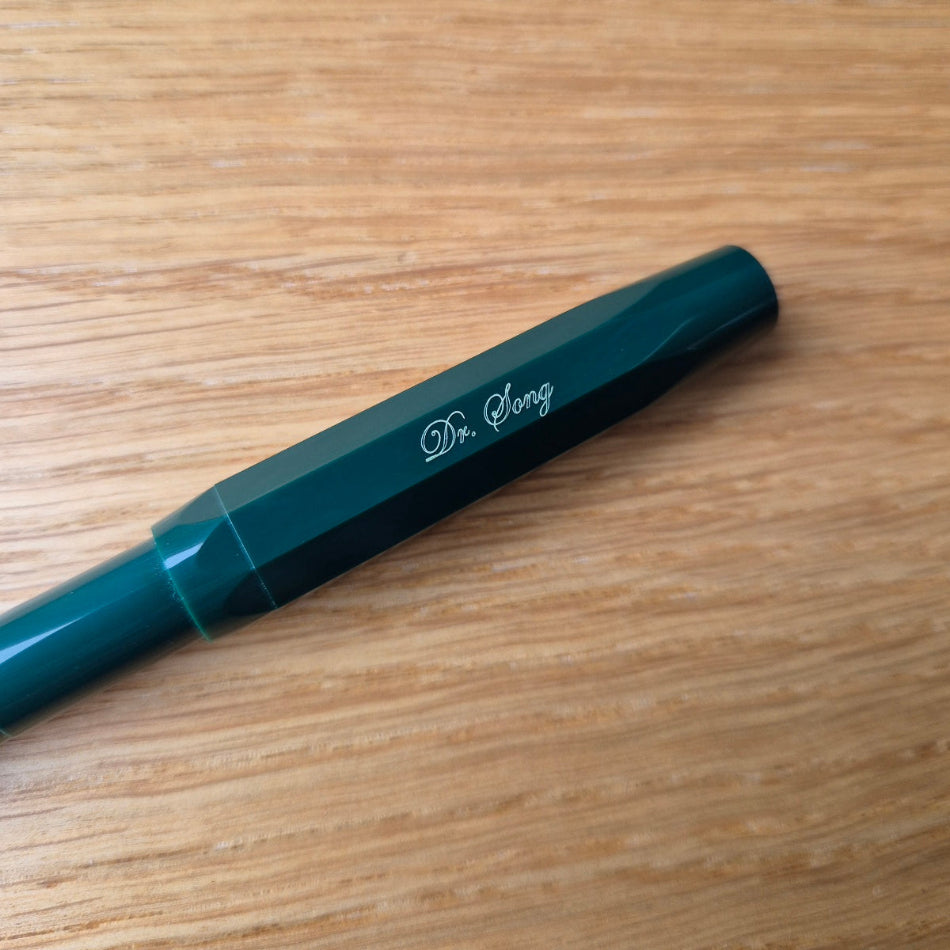 Small, script type engraving on a green Kaweco Sport pen
